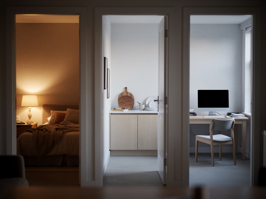 Three adjoining rooms of a house lit in three different white light colors: warm amber, neutral white, and cool white.