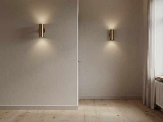 Two matching wall sconces mounted at eye level in a hallway entryway
