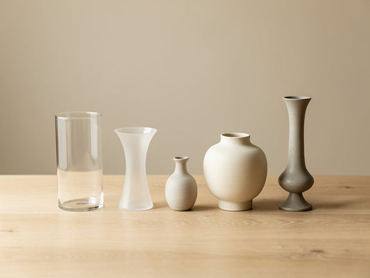 Five different vase shapes lined up on a table: cylinder, trumpet, bud, bouquet, and pedestal.